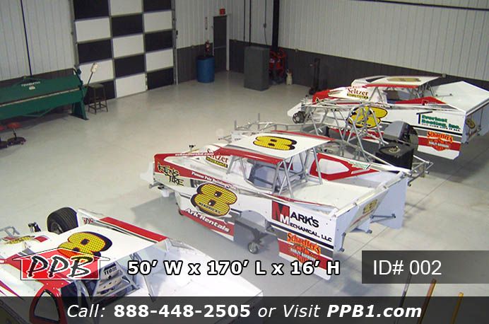 Overhead interior of 002 50x170x16 commercial workshop building with race cars on floor