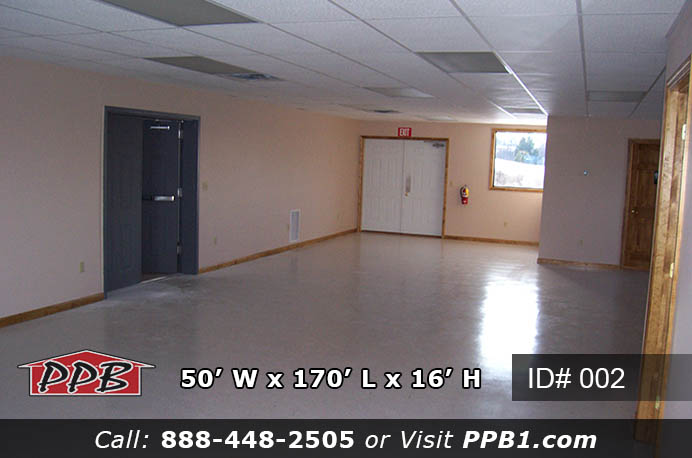 Overhead interior of 002 50x170x16 commercial workshop building with race cars on floor
