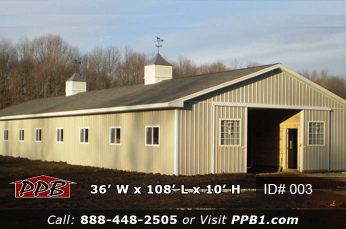 003 (36’Wx108’Lx10’H) 3 Full exterior of 003 36x108x10 equestrian post frame building with ash gray siding, charcoal shingle roof, and two cupolas