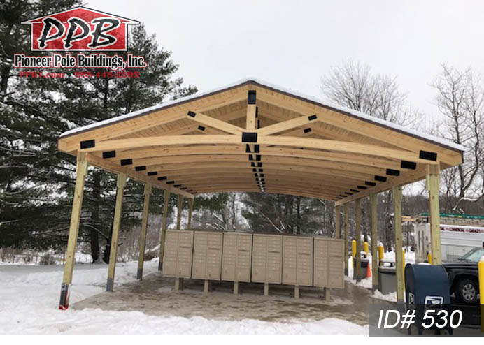 Pole Building Dimensions: 24’ W x 40’ L x 10’ 4” H (ID# 530) 24’ Custom Arched Glulam Trusses, 4’ on Center, 4/12 Pitch Colors: Roofing: Architectural Shingles, Pewter Gray Overhangs: Eaves & Gables: 1’ Gutter: 5K, Color: Brown 