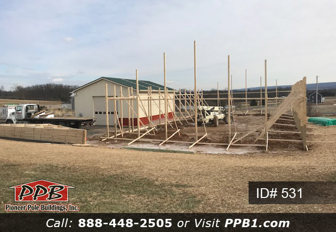Pole Building Dimensions: 50’ W x 100’ L x 14’ 6” H (ID# 531) 50’ Standard Trusses, 4’ on Center 4/12 Pitch Colors: Two-Tone Siding Color: Upper Color: Beige Lower Color: Red Roofing Color: Red Trim Color: Red