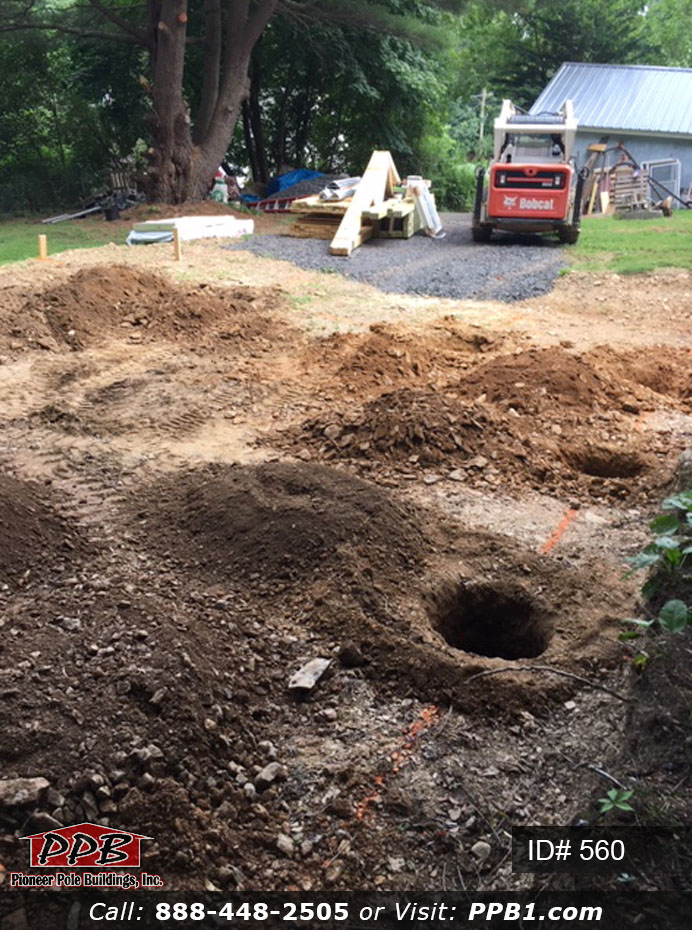 Digging holes for a pole building garage.