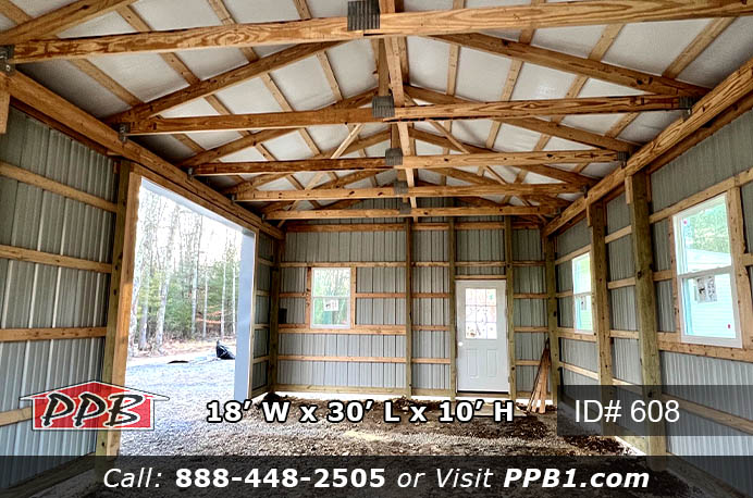 Inside a pole building with garage doors and windows