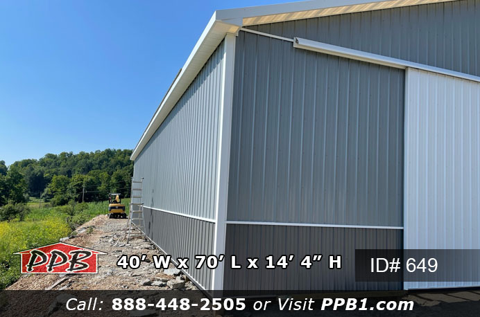 Farm Pole Building Dimensions 40’ W x 70’ L x 14’ 4” H (ID# 649) 40' Standard Trusses, 4’ on Center 4/12 Pitch Agricultural Pole Building Colors Upper Color: Slate Lower Color: Charcoal Roofing Color: Charcoal Trim Color: Brite White Farm Pole Building Openings (2) 16' x 14' Split Slider Non-Insulated Door with White Frames & 4' x 4' Fixed Windows with Grids (2) 3068 6-Panel Fiberglass (Insulated) Entry Doors Agricultural Pole Building Overhangs Eaves: 1' Gables: 1’ Soffit: White Vinyl Miscellaneous 70′ Ridge Vent Two-Tone Siding 70' of 2' Sidelights 2″ x 6″ Skirtboard .60 Treated with Barrier Tape