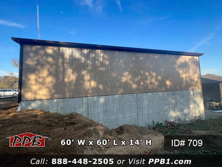 building with tan siding and concrete wall and foundation