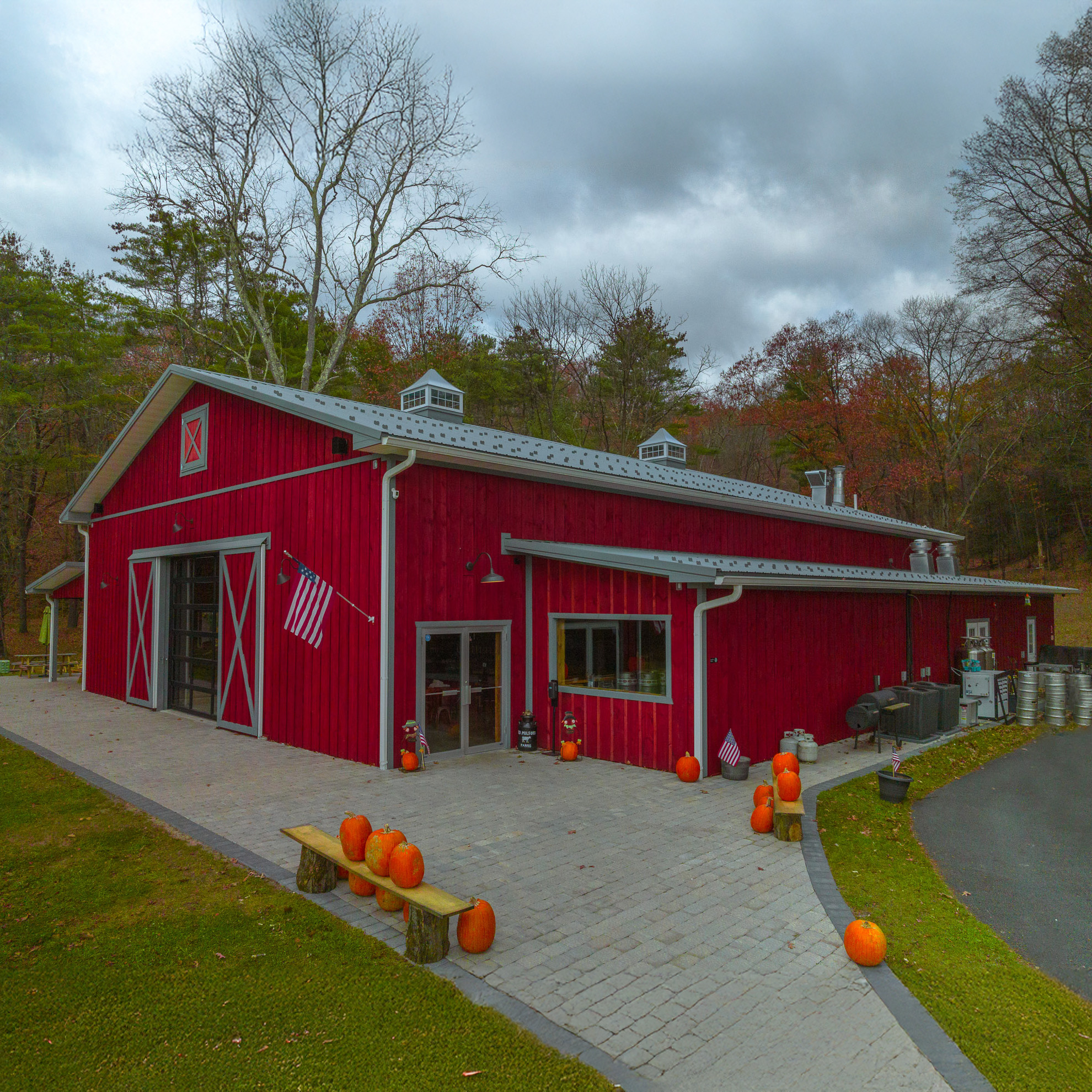 Rustic Red Barn Brewery in Pennsylvania Rustic post-frame brewery with red siding by custom barn builders in Pennsylvania