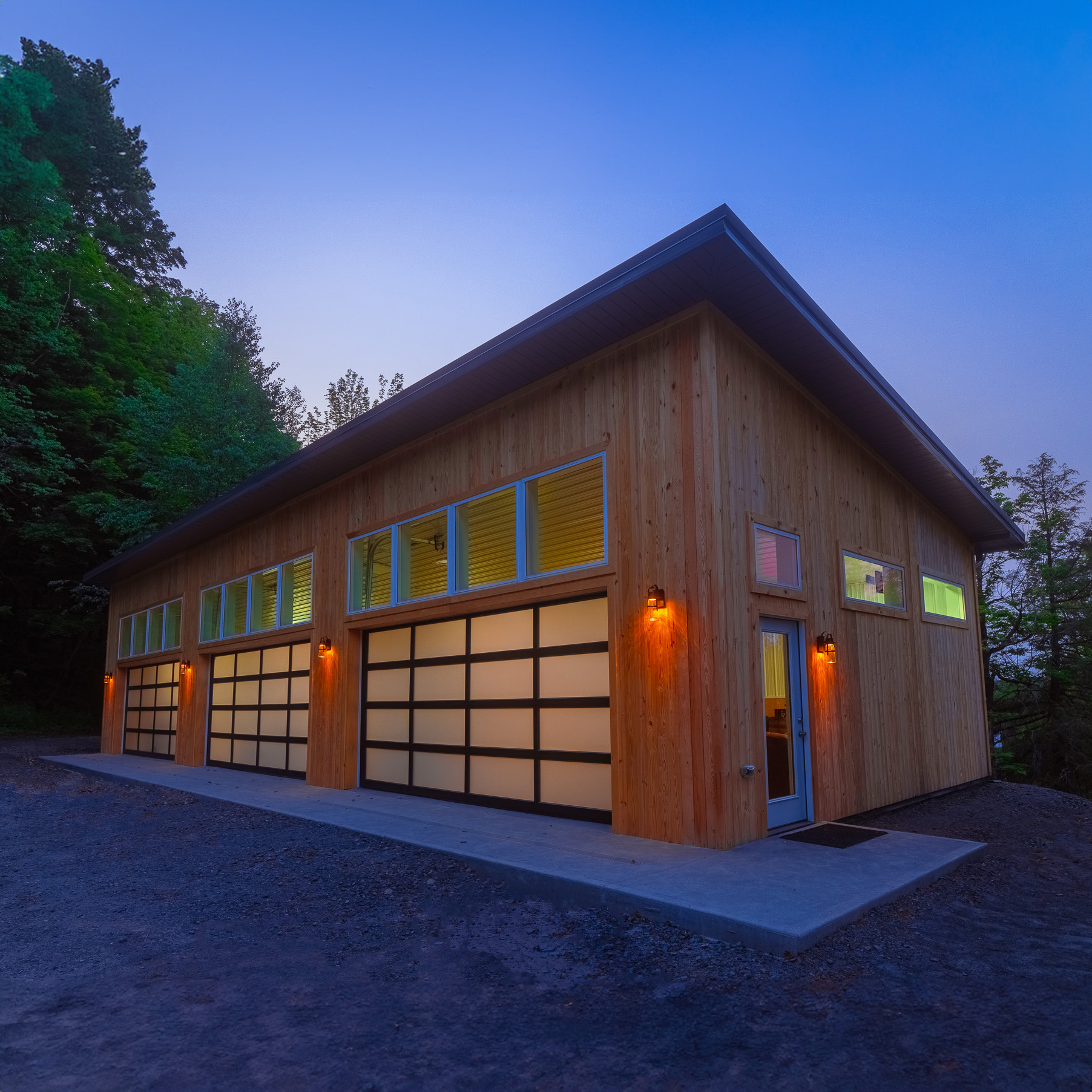 Contemporary Glass-Door Pole Building in PA Modern post-frame structure with frosted glass doors by barn construction specialists close to me in Pennsylvania