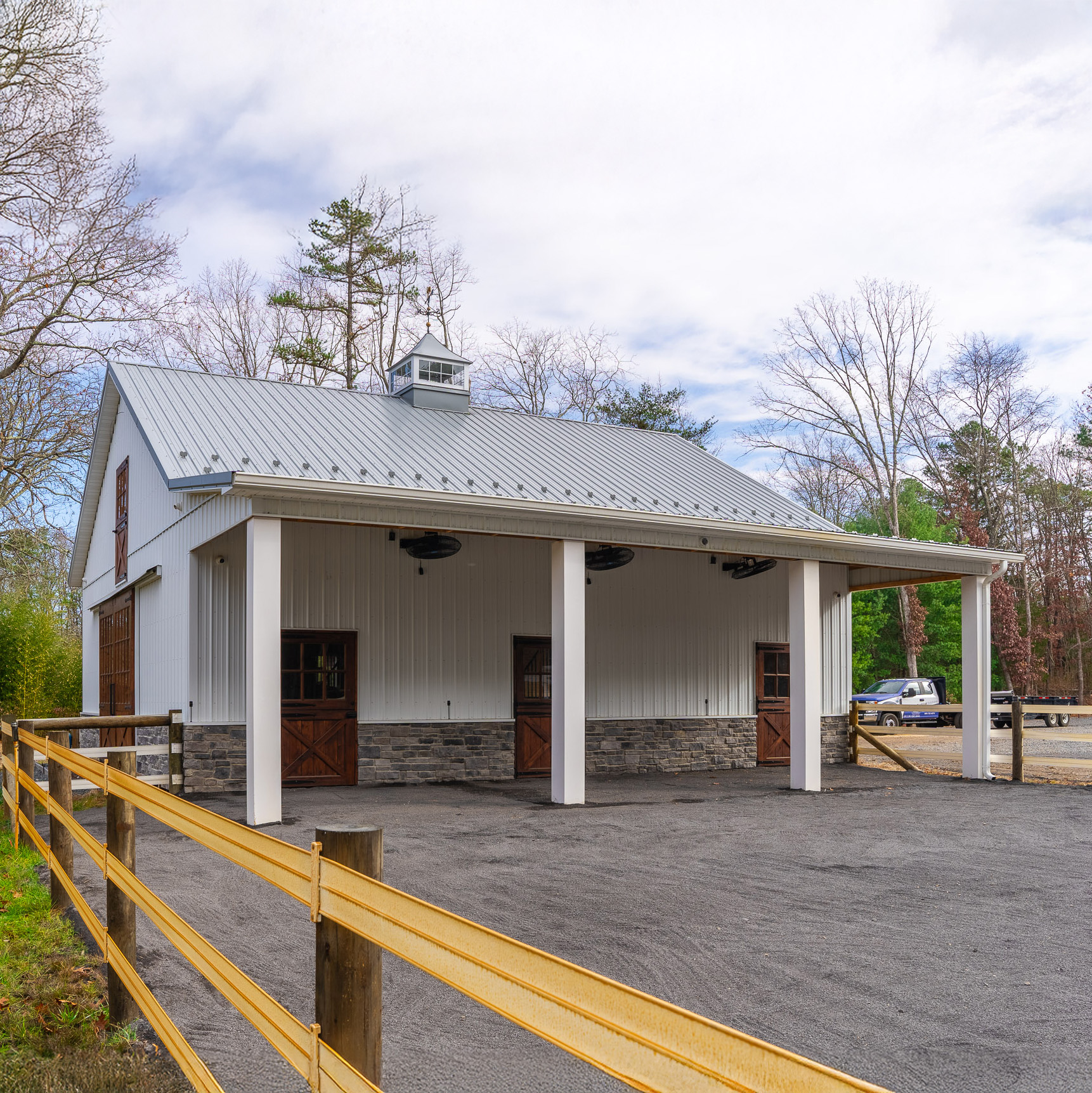 Engineered Post-Frame Barn with Stone Finish – New Jersey Engineered barn with stone base and custom wood doors constructed by post-frame barn contractors in New Jersey